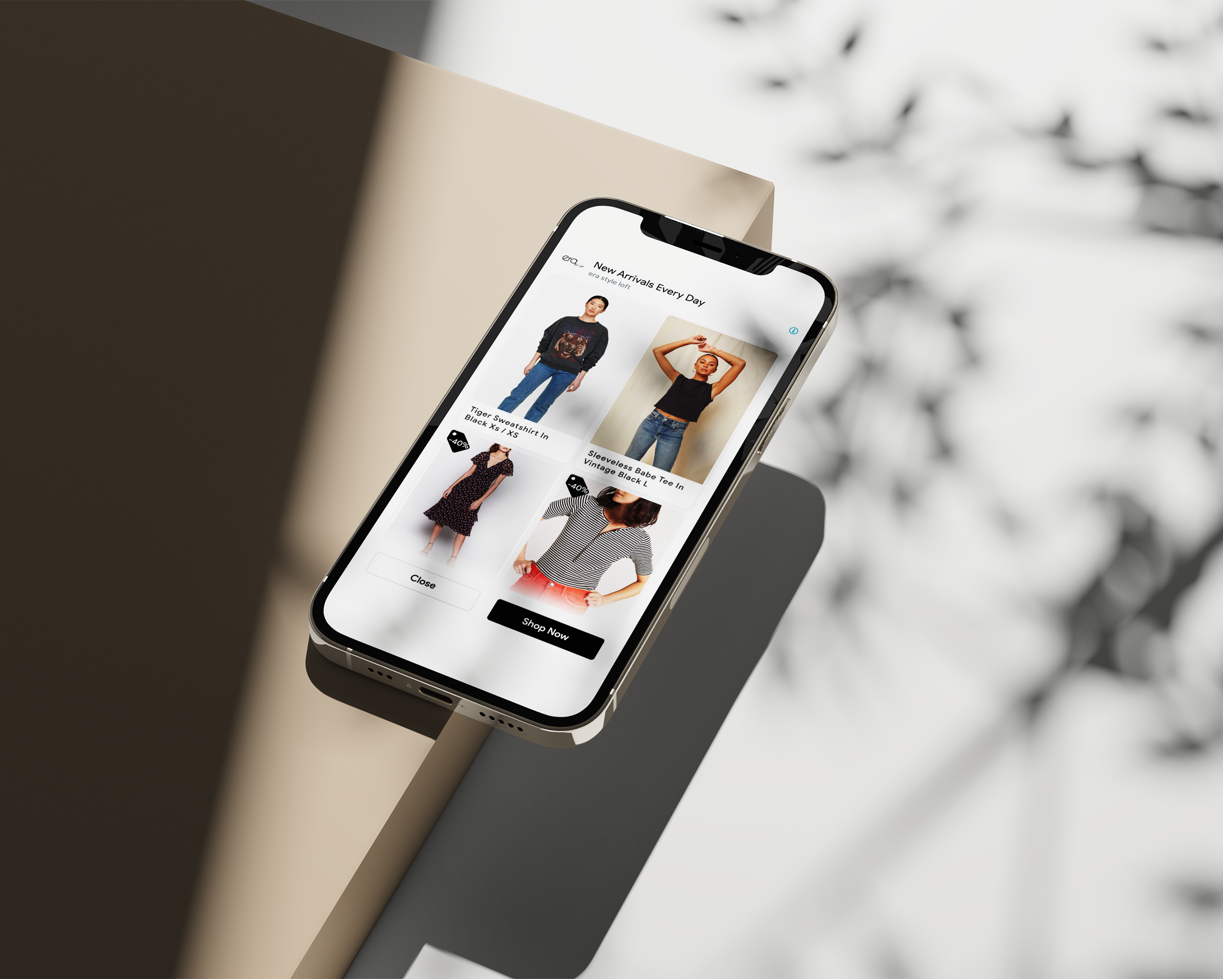smartphone showing Era Style Loft digital ads of four clothing items